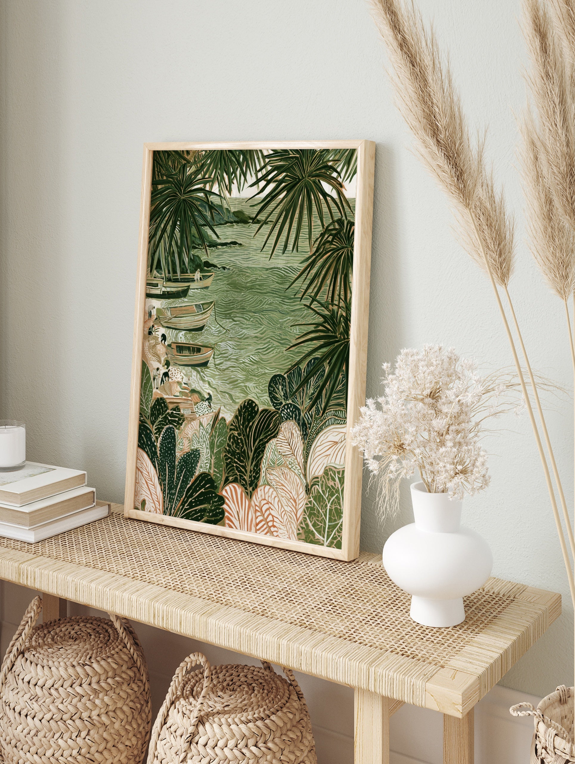 Coastal fishing boats on sand surrounded by large tropical palm leaves in a green, in an alternate framed mockup
