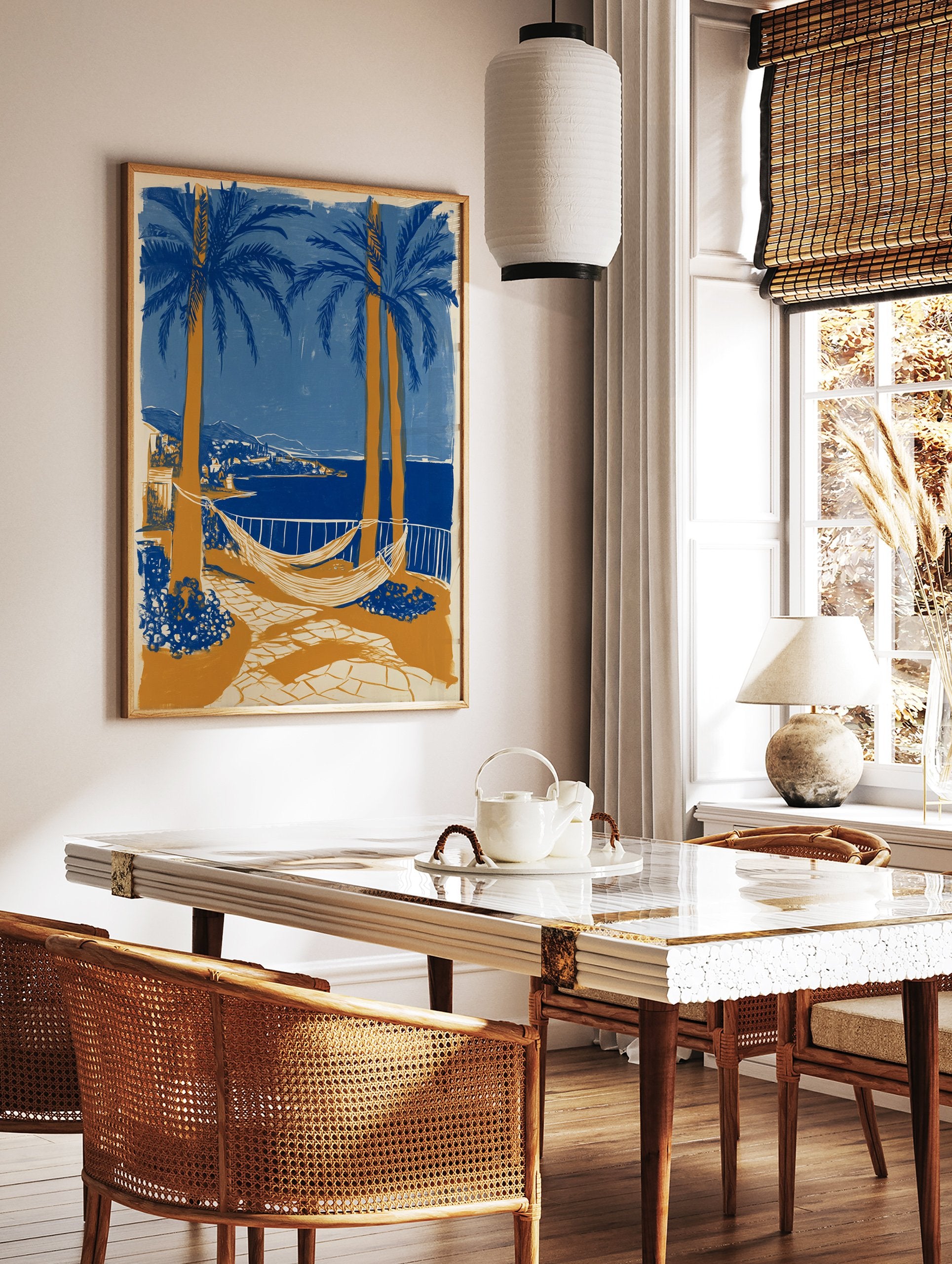 Coastal landscape poster with blue palm trees, orange trunks, white hammocks, a blue sea, and a distant town. - Image 2