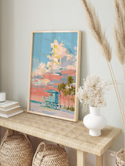 Painterly art print of a teal lifeguard hut on a beach with palm trees, under a blue and, in an alternate framed mockup