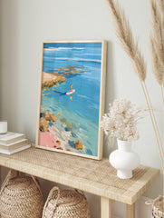 Impressionistic painting of person paddleboarding on clear blue water near rocky coast and, in an alternate framed mockup