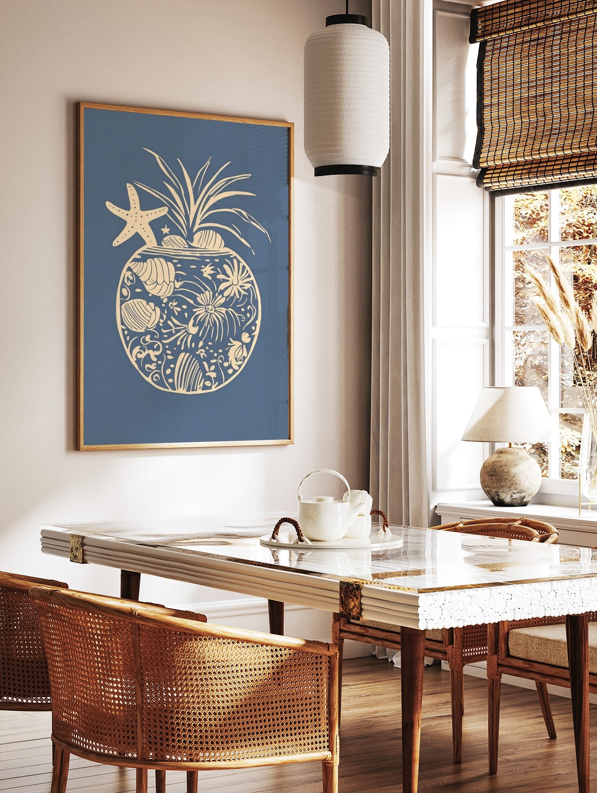 Coastal pineapple illustration with starfish, seashells, and coral elements on a blue background, in a styled room mockup