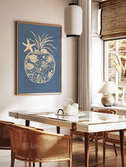 Coastal pineapple illustration with starfish, seashells, and coral elements on a blue background, in a styled room mockup