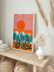 Illustrative coastal wall art with orange sun, teal waves, and orange and purple tropical, in an alternate framed mockup