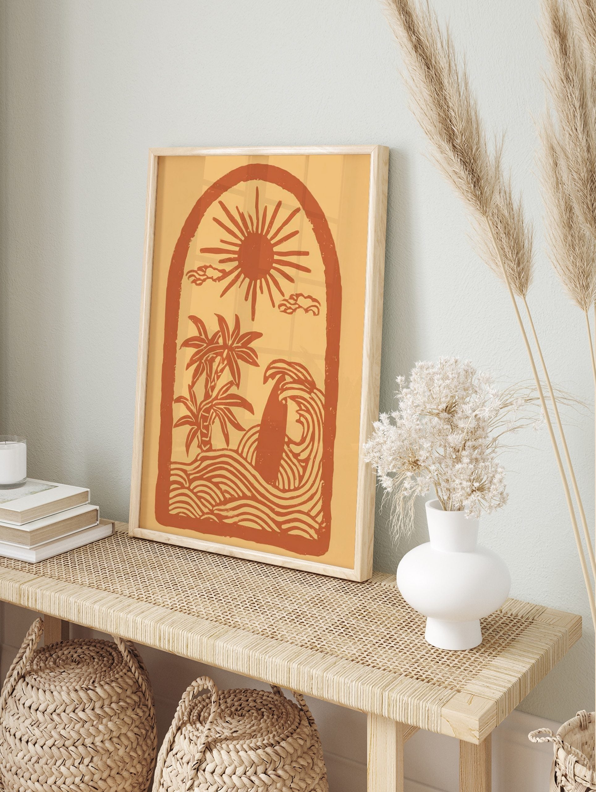 Illustrative coastal scene art print with sun, palm trees, surfboard in waves, within an arch, in an alternate framed mockup