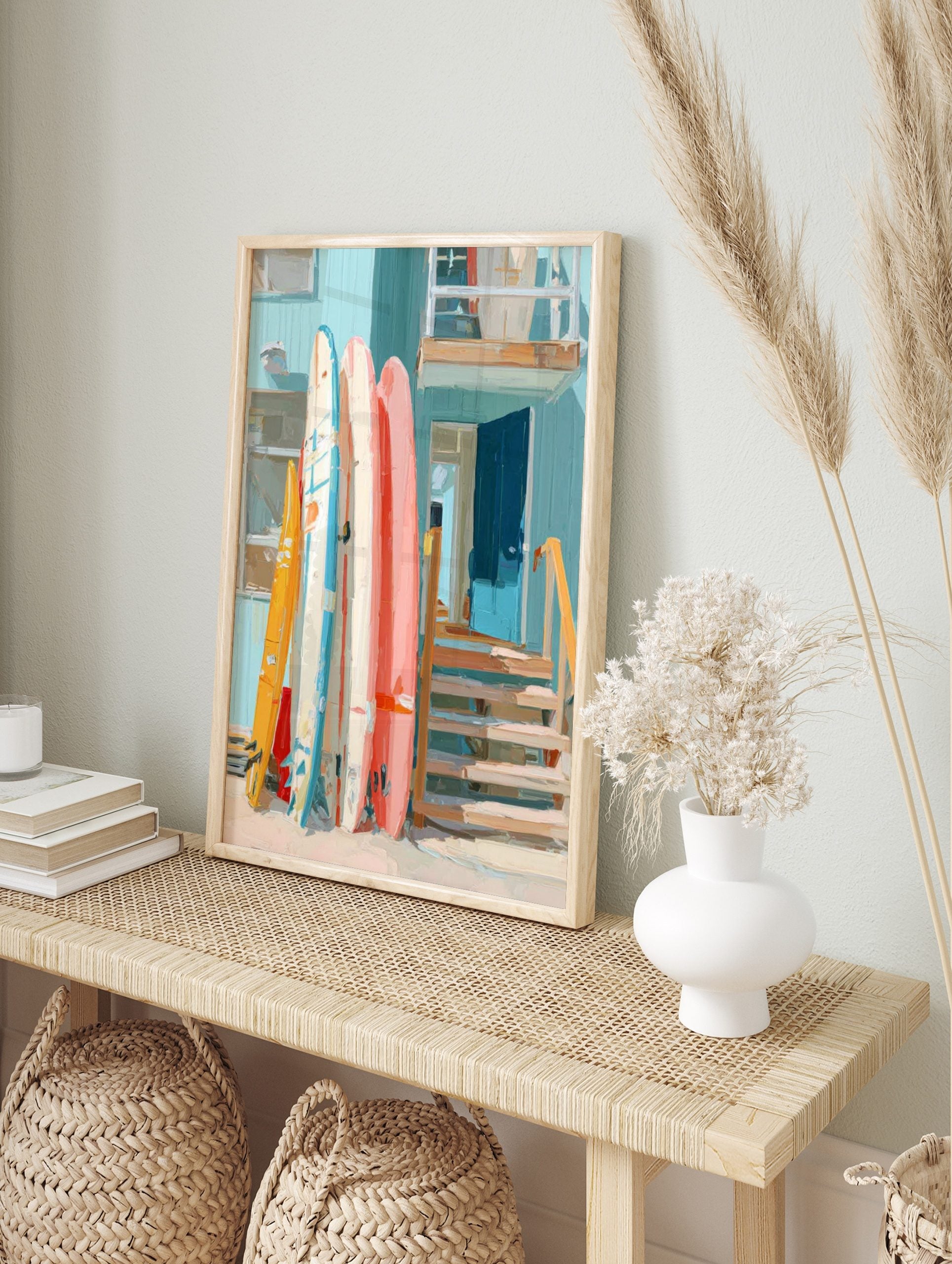 Colourful surfboards leaning against a light blue beach house with an open blue door and, in an alternate framed mockup