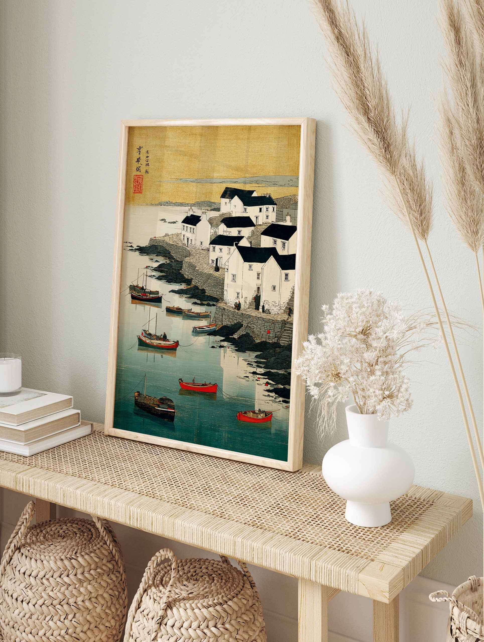 Coastal village with white houses, dark roofs, boats in blue water, rocky shore, Japanese, in an alternate framed mockup