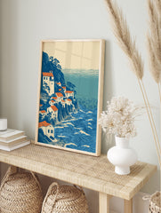 Ukiyo-e style coastal village wall art print with white houses, orange roofs, blue cliffs, and a wavy blue ocean. - Image 3