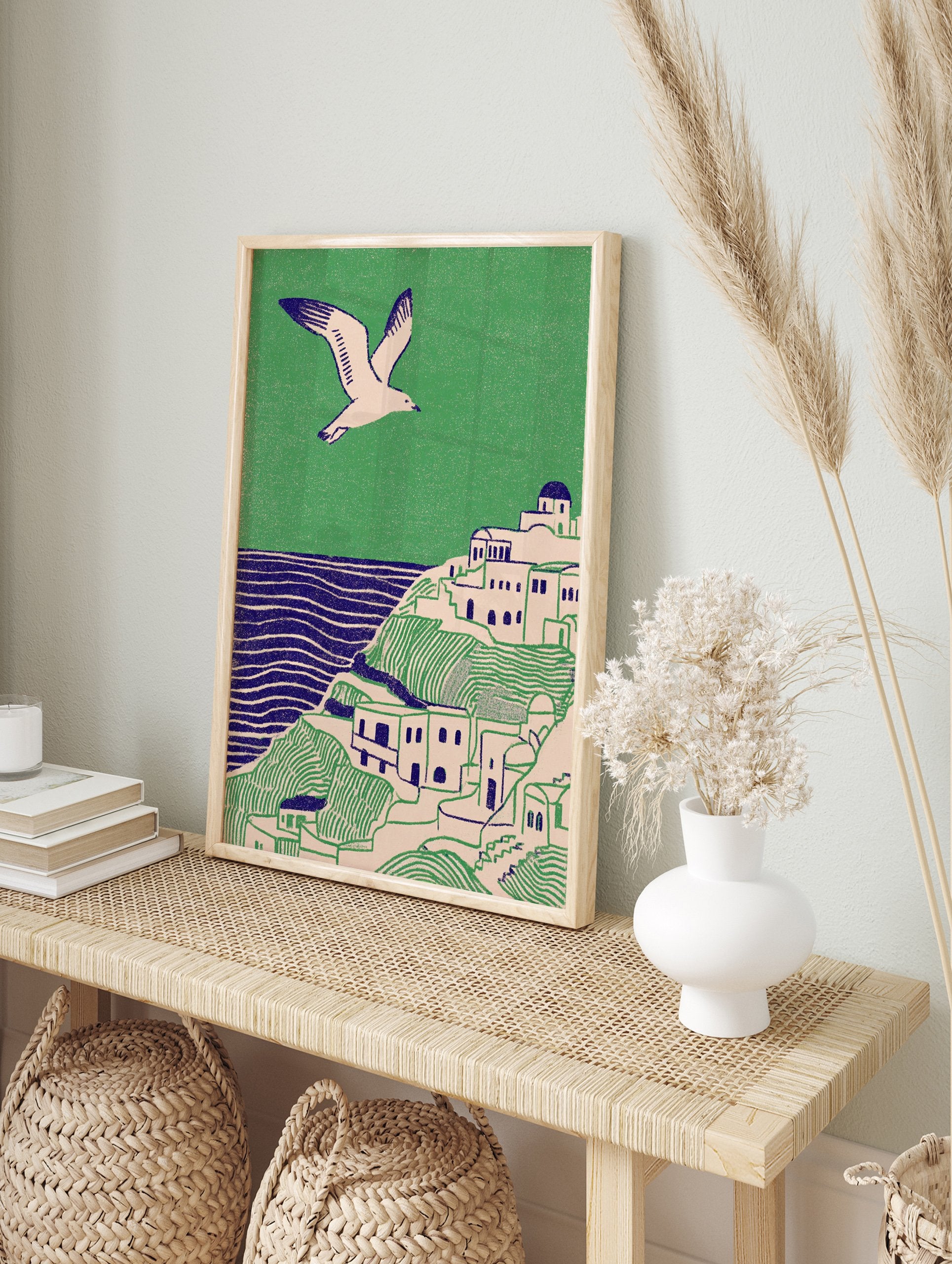 Illustrative coastal wall art print showing a white village on green hills, blue sea, and a flying seagull. - Image 3