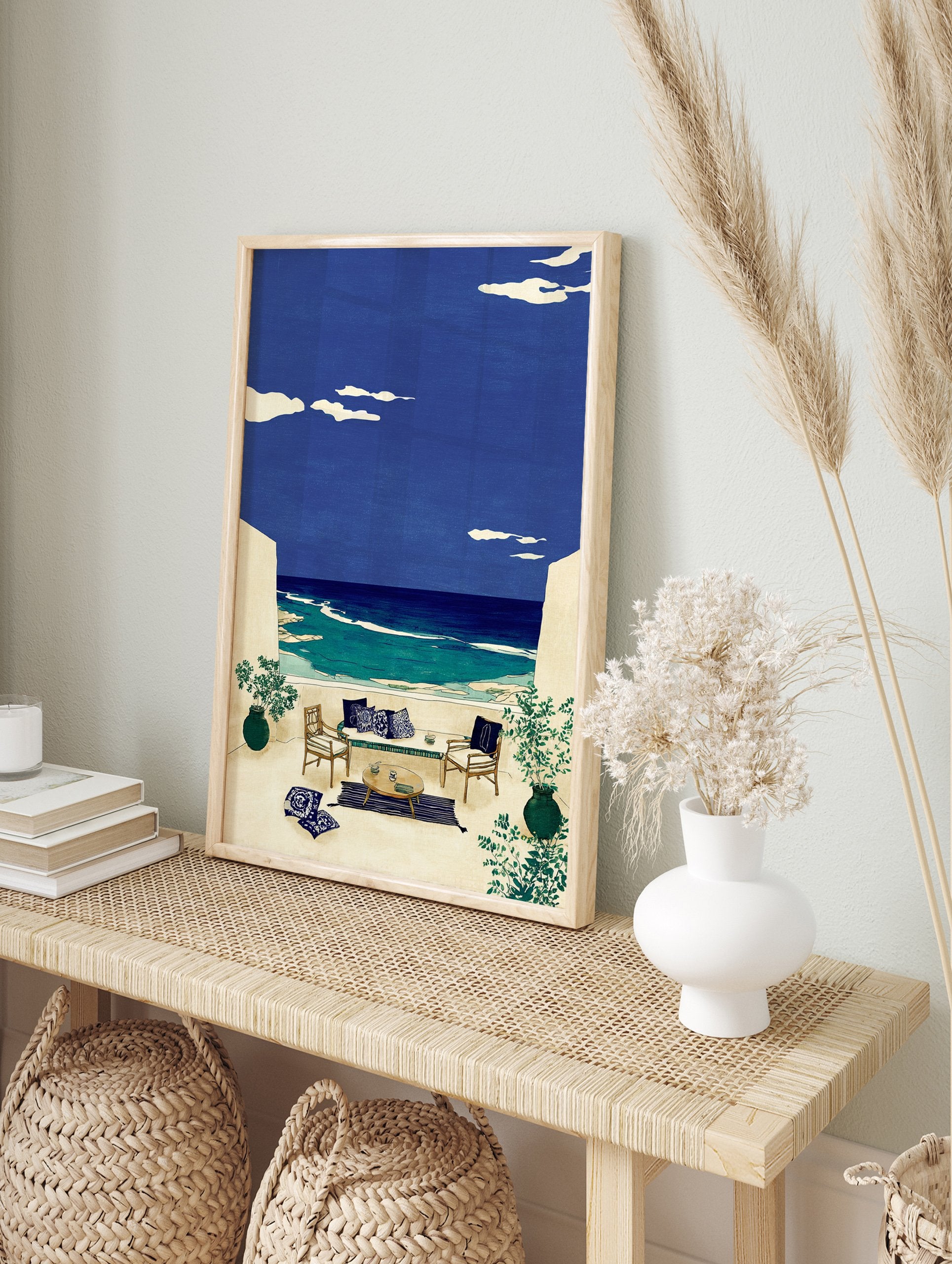 Illustrative coastal wall art of an outdoor terrace with seating overlooking a blue ocean and sky with clouds. - Image 3