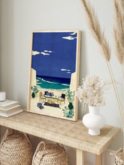 Illustrative coastal wall art of an outdoor terrace with seating overlooking a blue ocean and sky with clouds. - Image 3
