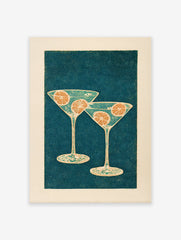 Illustrative cocktail wall art featuring two martini glasses with orange slices on a dark teal dotted background.