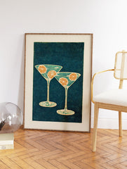 Illustrative cocktail wall art featuring two martini glasses with orange slices on a dark teal dotted background. - Image 2