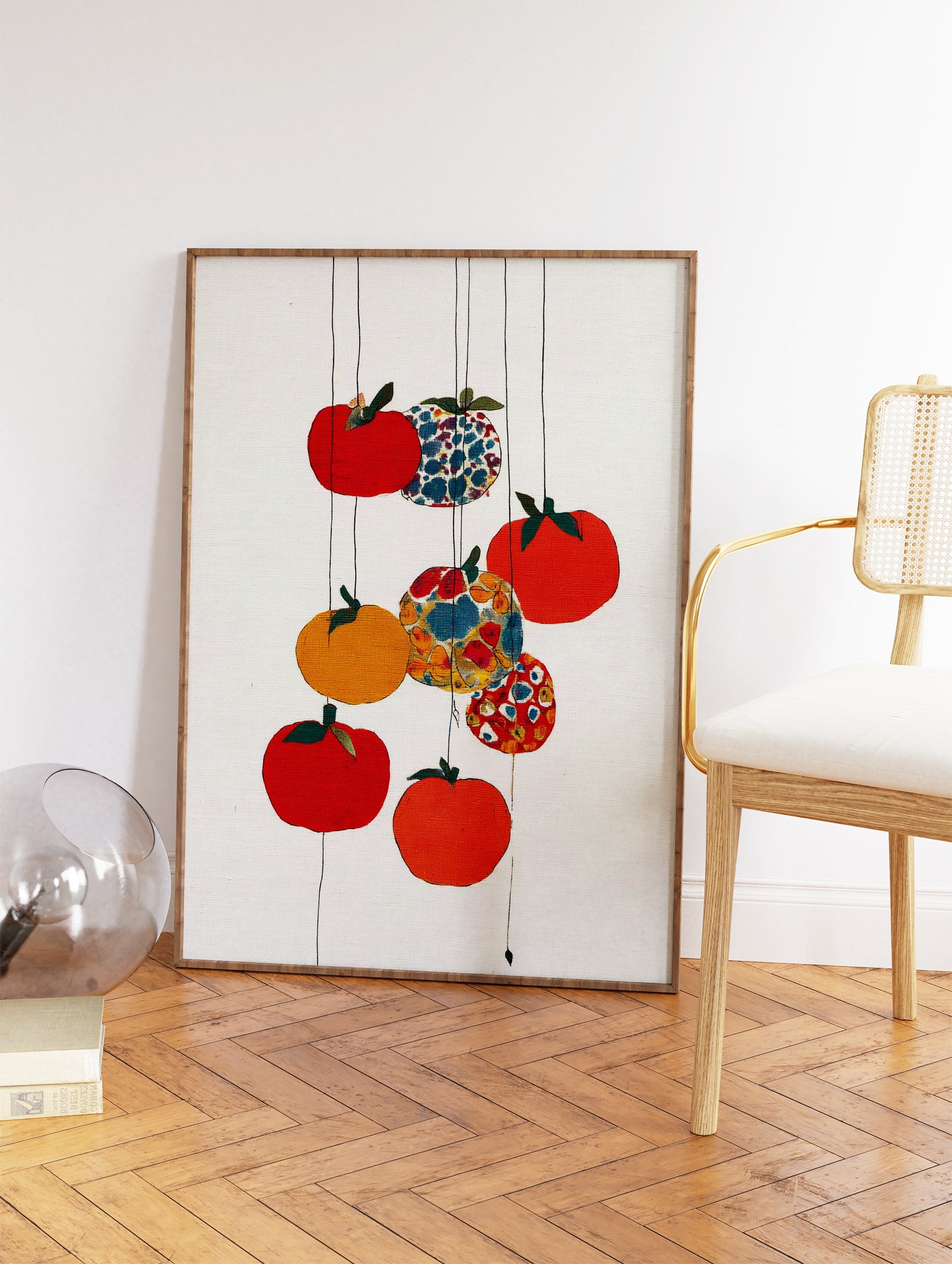 Colorful fruit wall art with red, orange, yellow, and patterned fruits hanging on thin lines against a white textured background. - Image 2