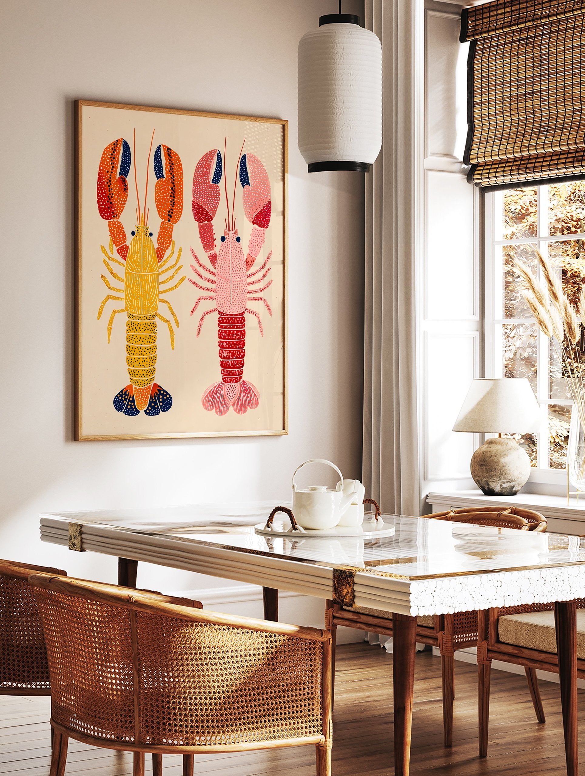 Two colorful illustrative lobster wall art prints, one yellow and orange, one pink and red, on a light beige background. - Image 3