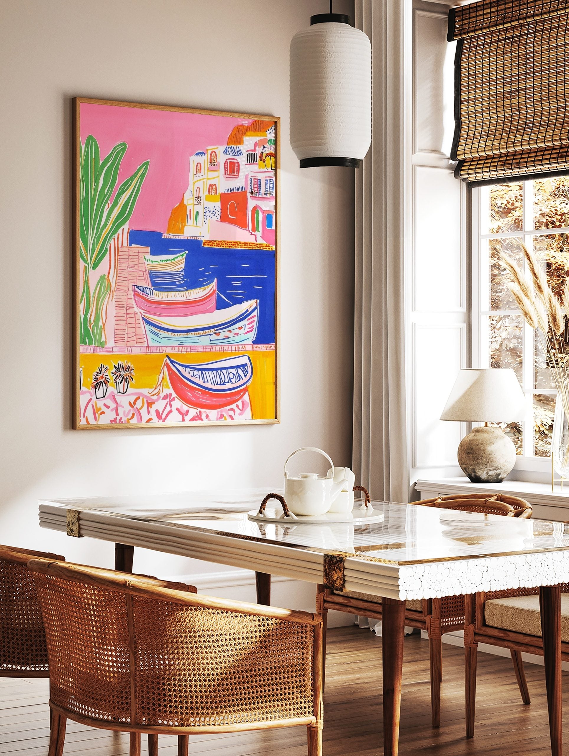 Colourful illustrative coastal town art print with boats in blue water, white buildings, and green, in a styled room mockup