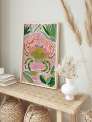 Colourful crab illustration wall art print with orange claws, green legs, and spotted shell, in an alternate framed mockup