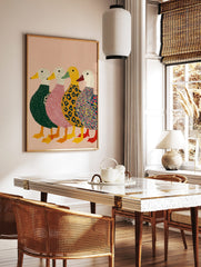 Four colourful illustrative ducks in green, pink, leopard, and multi-patterned bodies on a pink, in a styled room mockup