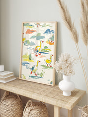 Colourful illustrative wall art print of yellow ducks with orange beaks walking through green, in an alternate framed mockup