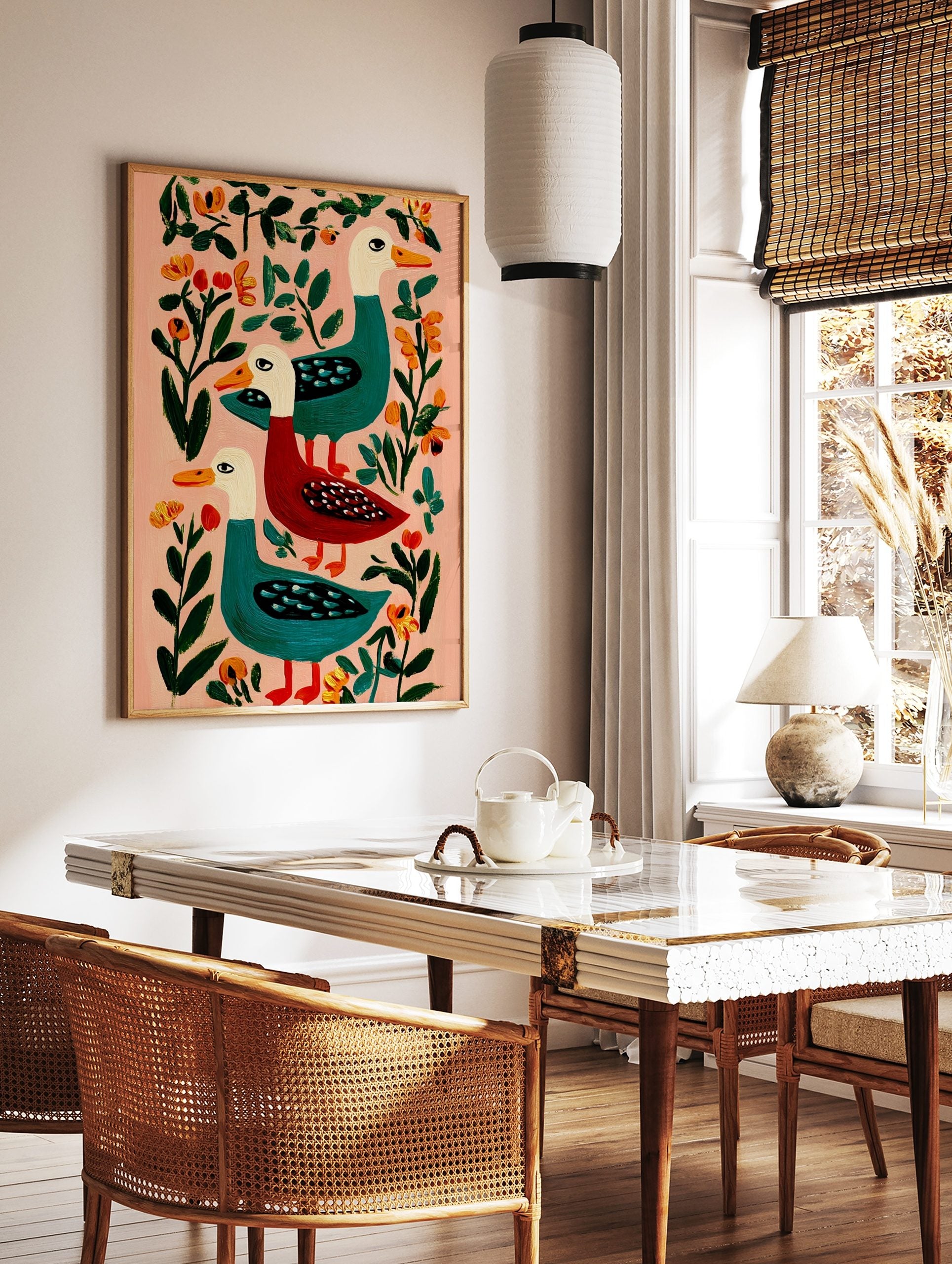 Illustrative folk art print of three colourful ducks, two teal and one red, with orange beaks, on a, in a styled room mockup