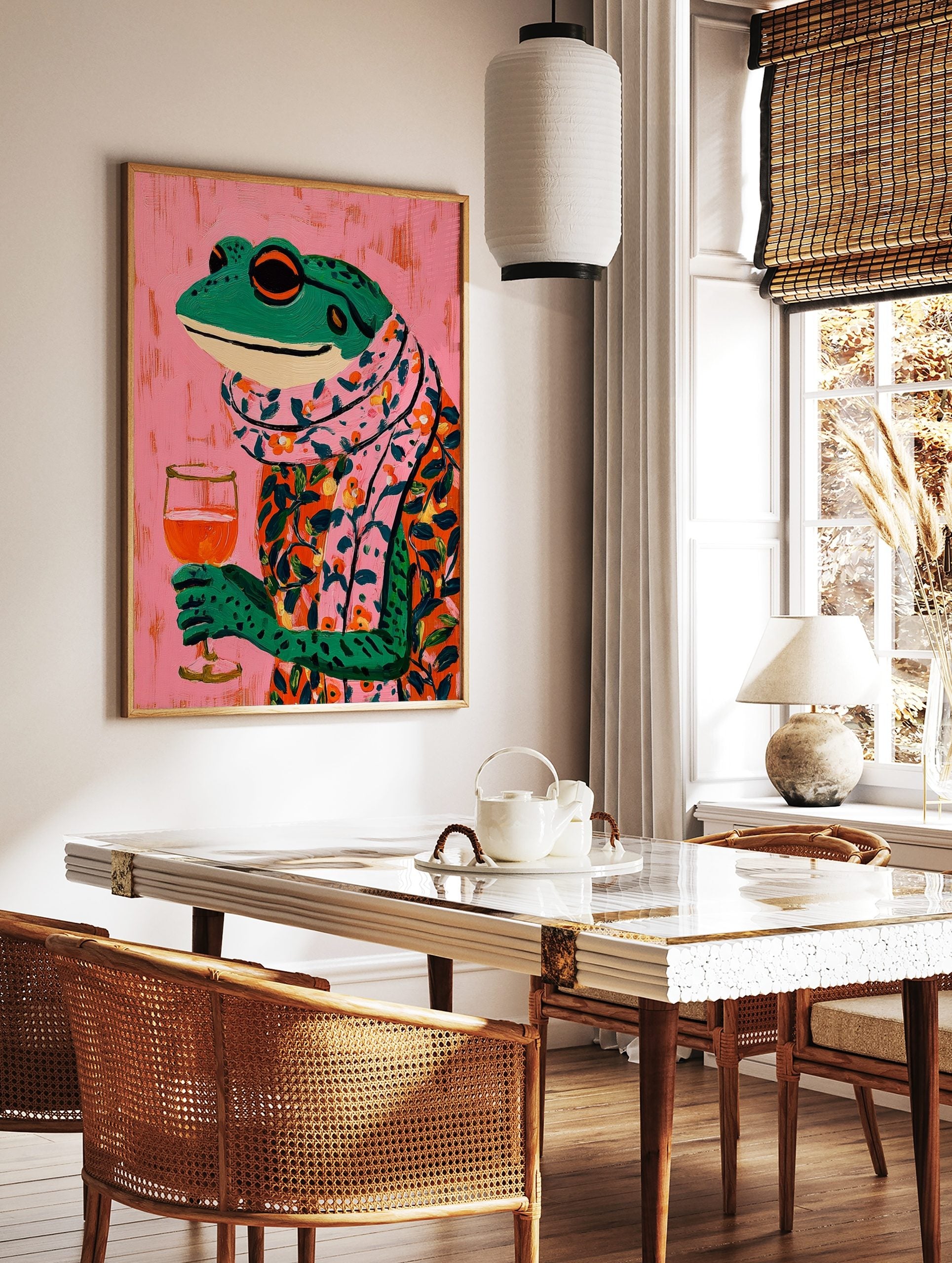 Illustrative colourful frog in floral shirt and scarf holding a wine glass on pink background, in a styled room mockup