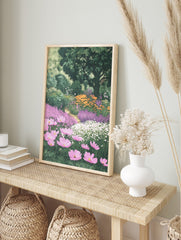 Lush garden print with pink cosmos, purple and orange flowers, green trees, and winding path, in an alternate framed mockup