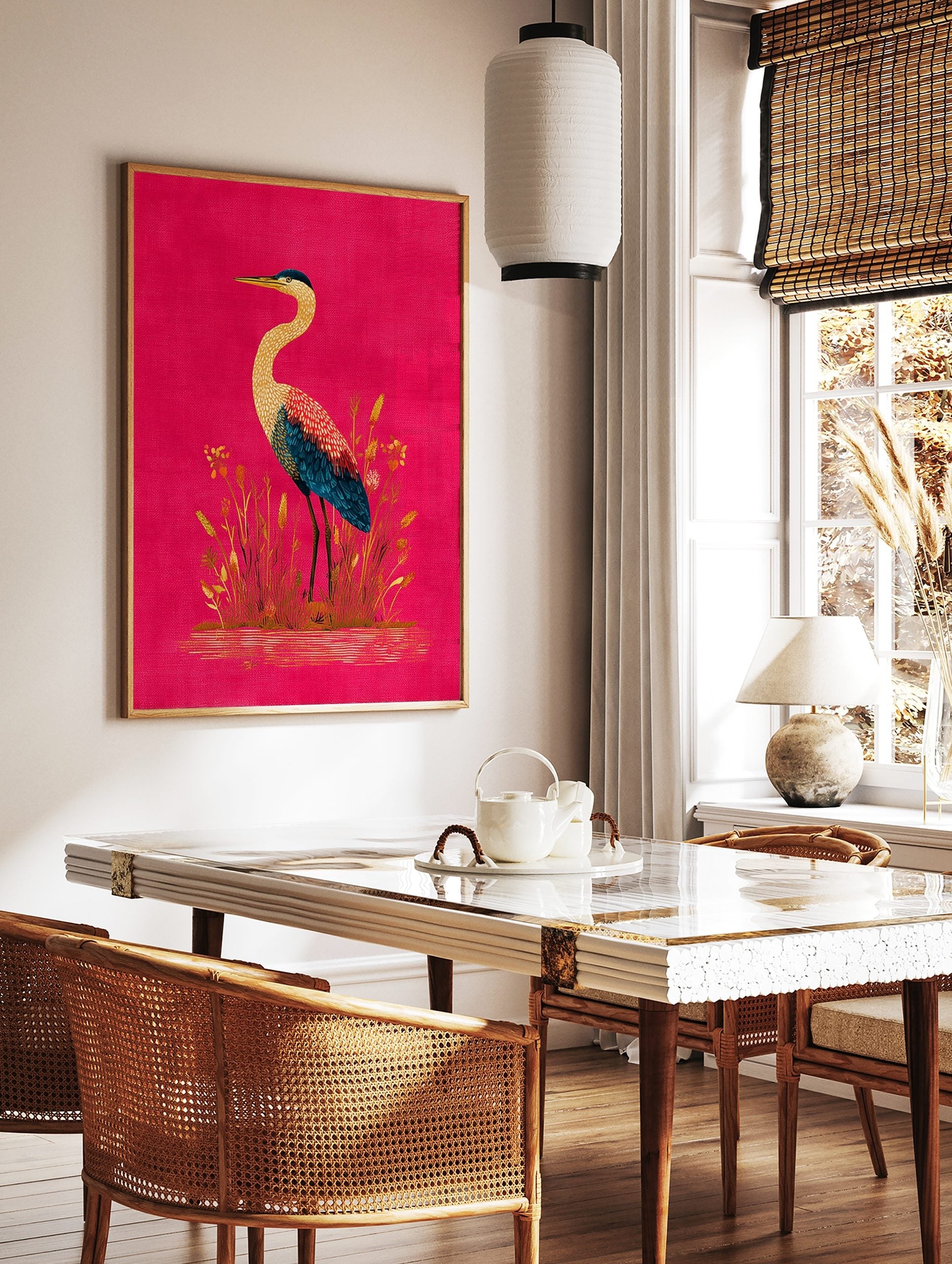 Illustrative heron bird with yellow, red, and blue feathers standing in reeds on a fuchsia, in a styled room mockup