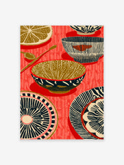Illustrative kitchenware print with patterned bowls, plates, spoons, and a lemon slice on a red background
