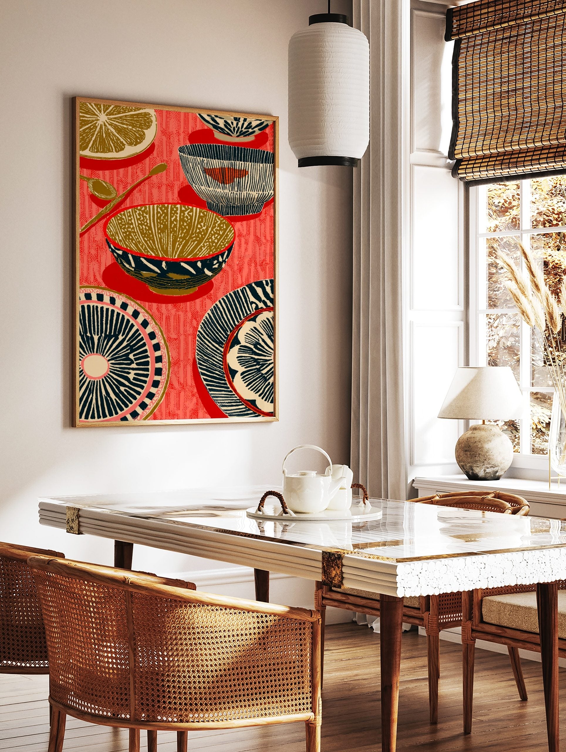 Illustrative kitchenware print with patterned bowls, plates, spoons, and a lemon slice on a red, in a styled room mockup