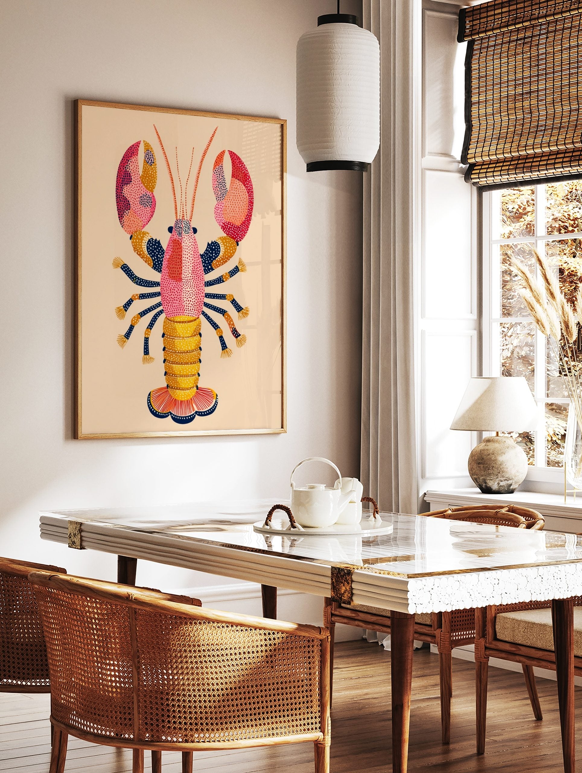 Colourful illustrative lobster wall art print with pink, orange, yellow, and navy blue dot patterns, in a styled room mockup