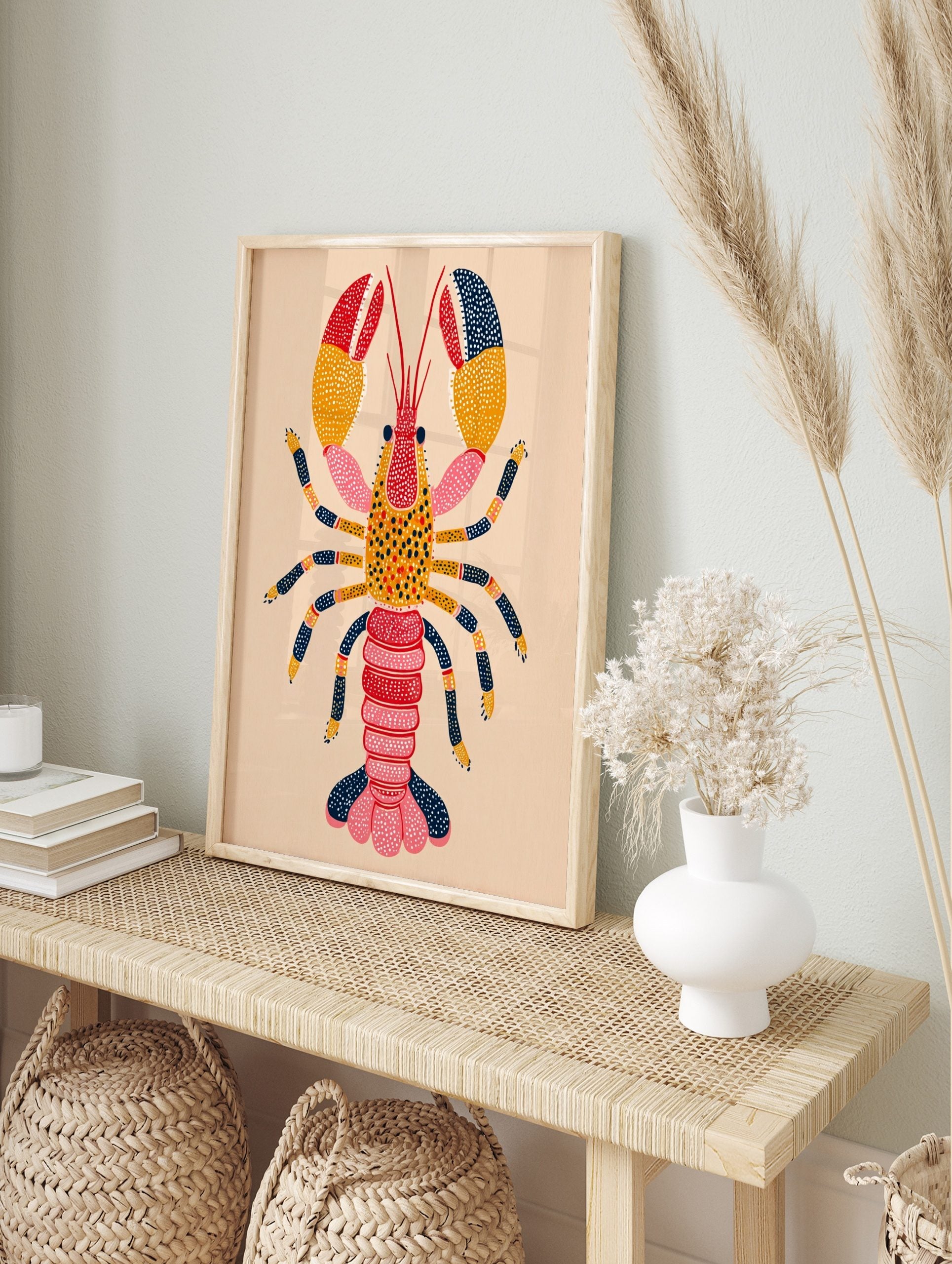 Colourful illustrative lobster wall art print with red, orange, pink, and navy blue segmented, in an alternate framed mockup