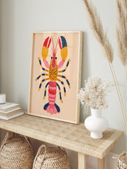 Colourful illustrative lobster wall art print with red, orange, pink, and navy blue segmented, in an alternate framed mockup