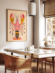 Illustrative lobster art print with pink body, yellow and red dotted claws, and navy accents on a, in a styled room mockup