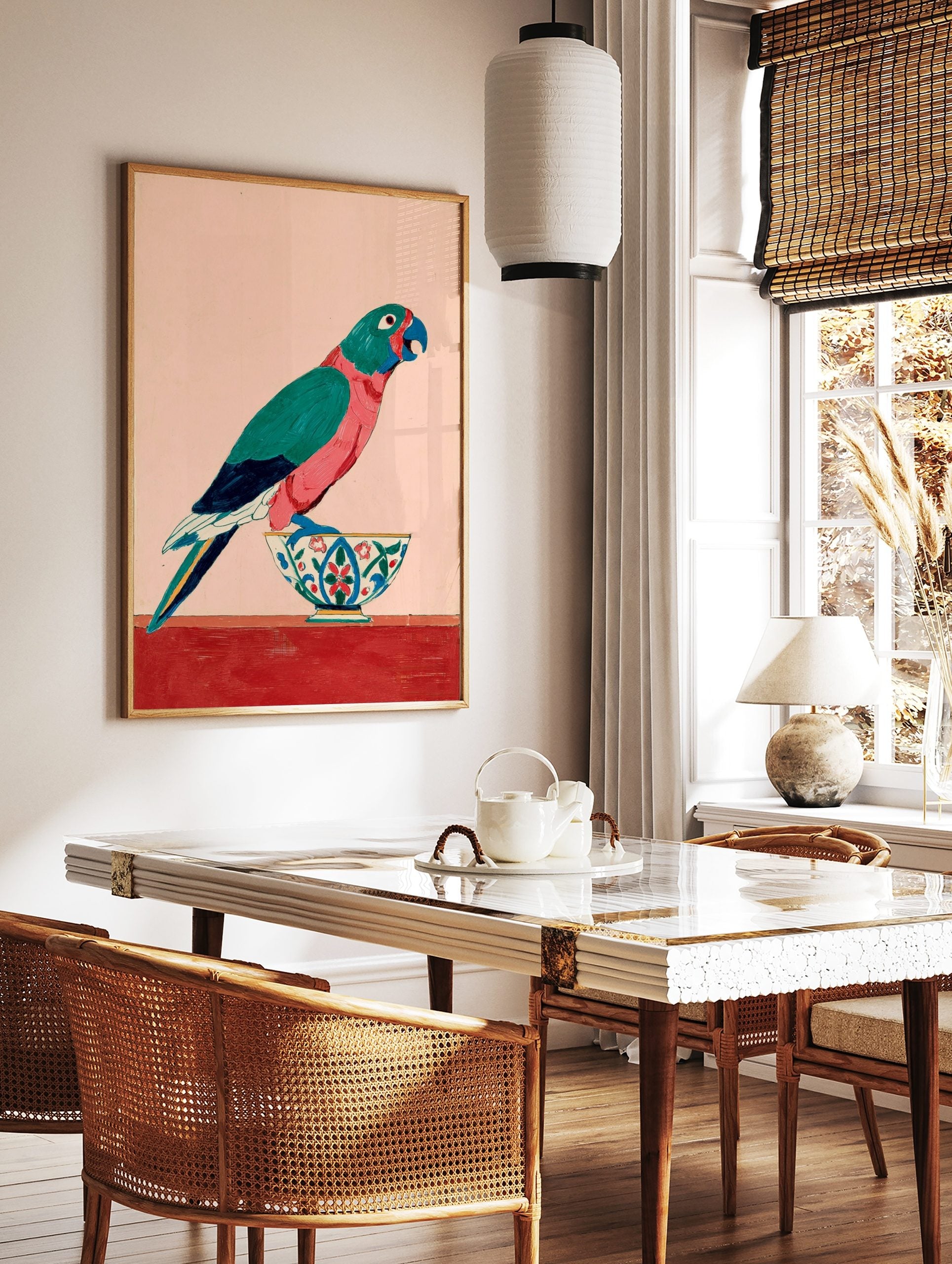 Colourful parrot with teal and pink feathers standing on a decorative bowl against a pale pink, in a styled room mockup