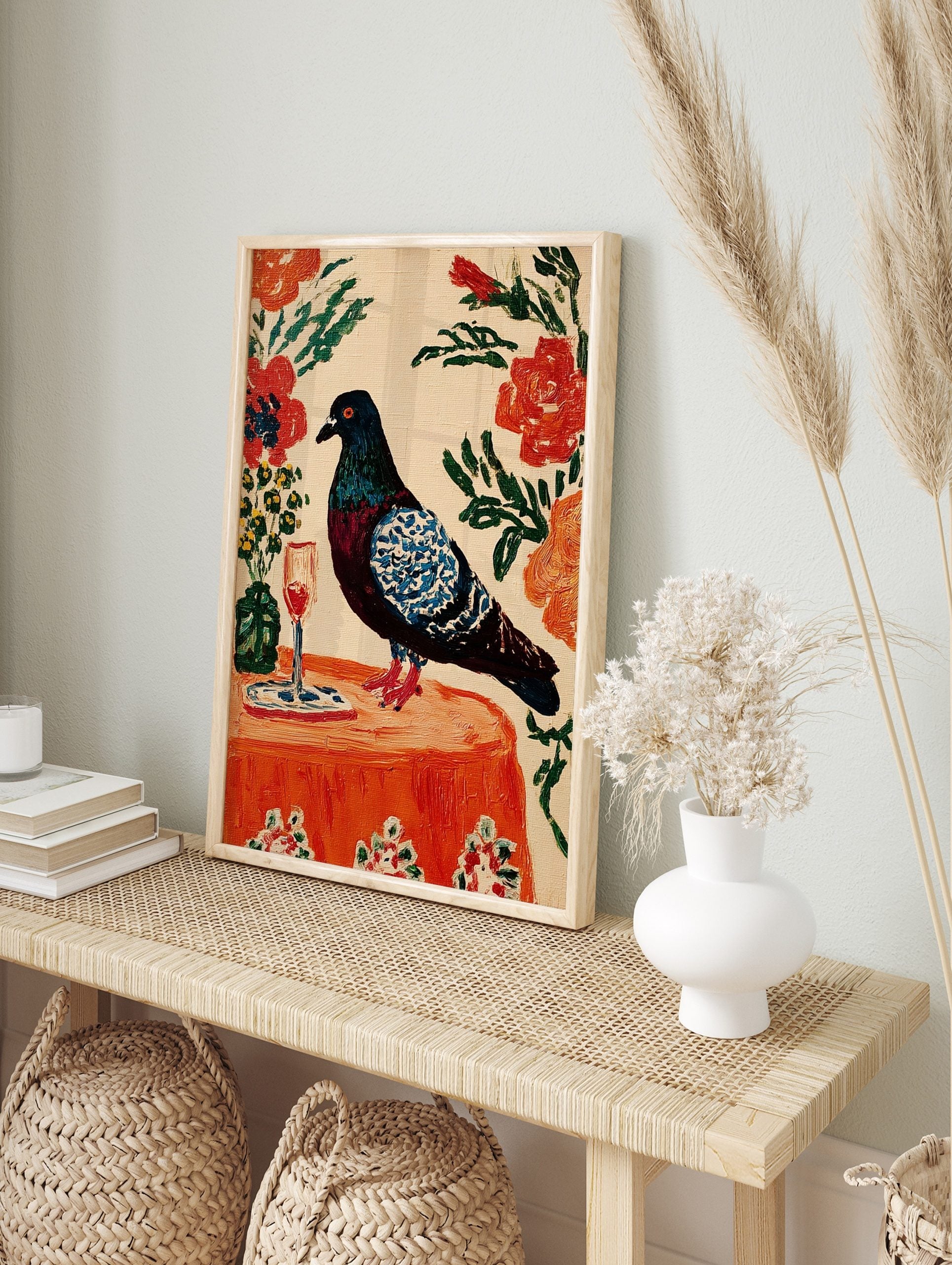Painterly pigeon with blue wings on an orange table with wine glass and flowers, in an alternate framed mockup