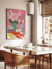 Illustrative still life print of a red lobster, oysters, lemon, and pink flowers in vases on a pink, in a styled room mockup