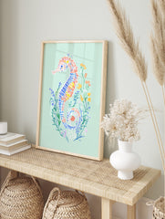 Colourful illustrative seahorse art print with blue, orange, yellow patterns on mint green, in an alternate framed mockup