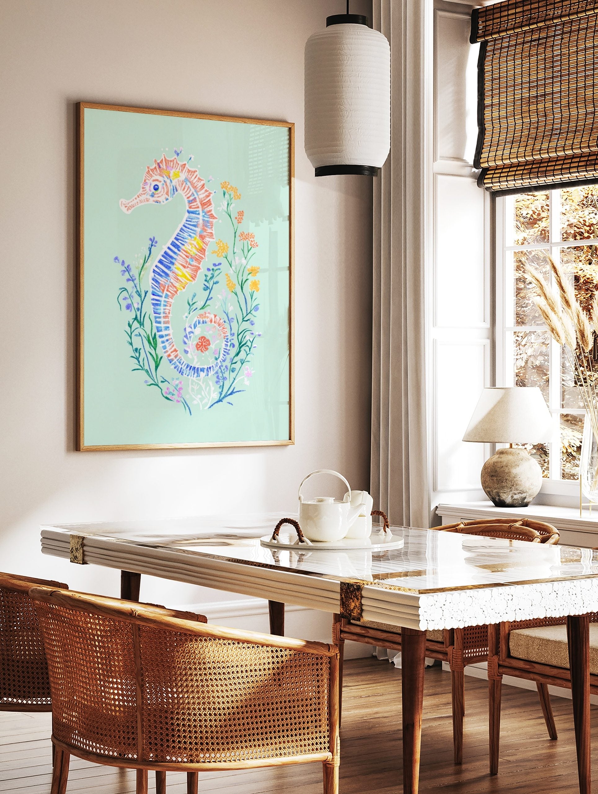 Colourful illustrative seahorse art print with blue, orange, yellow patterns on mint green, in a styled room mockup