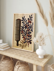 Vintage style illustration of a wooden comb and an olive branch with dark fruit on a textured, in an alternate framed mockup