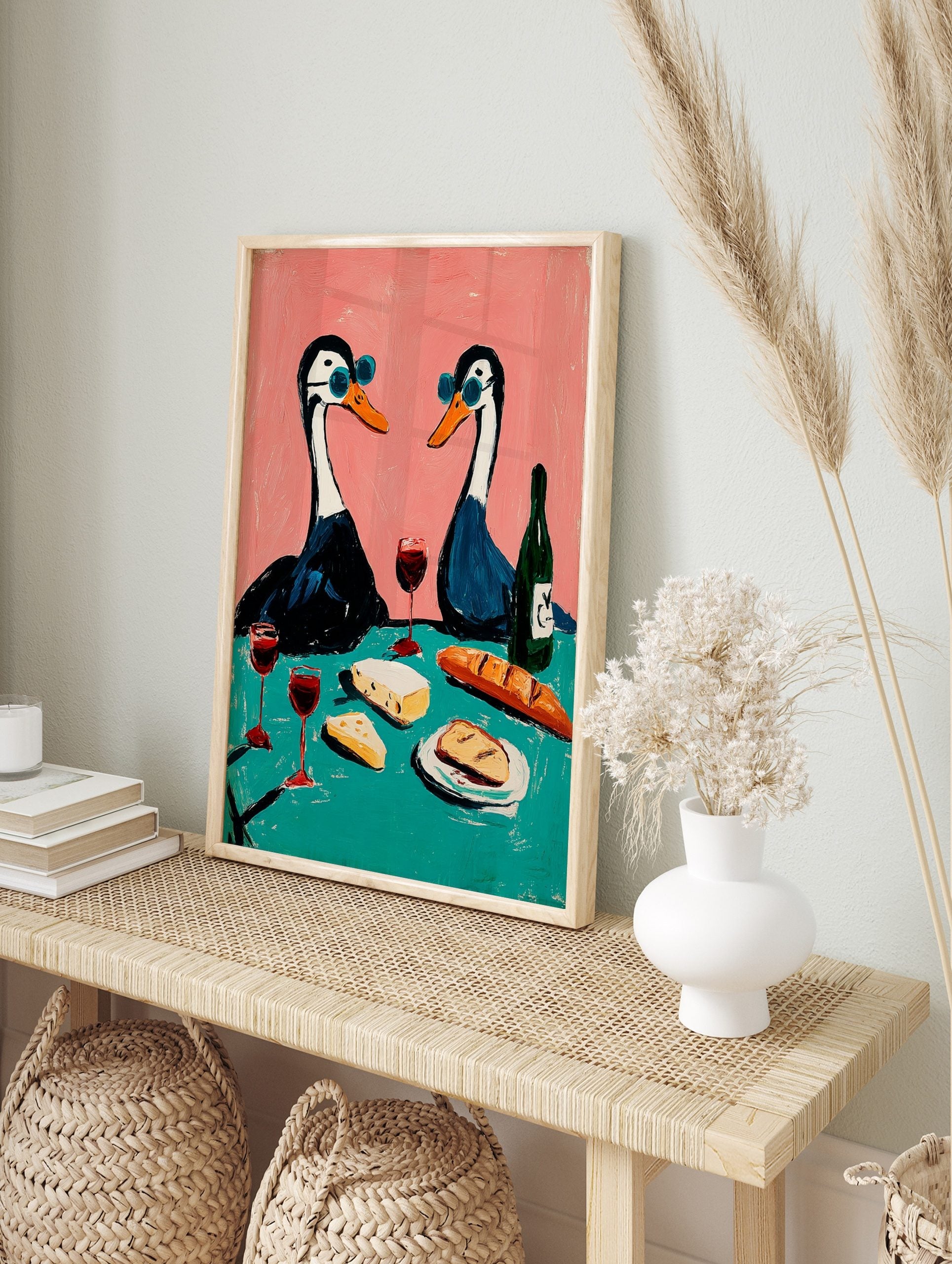 Illustrative art print of two geese in blue sunglasses having a picnic with wine, cheese, and, in an alternate framed mockup