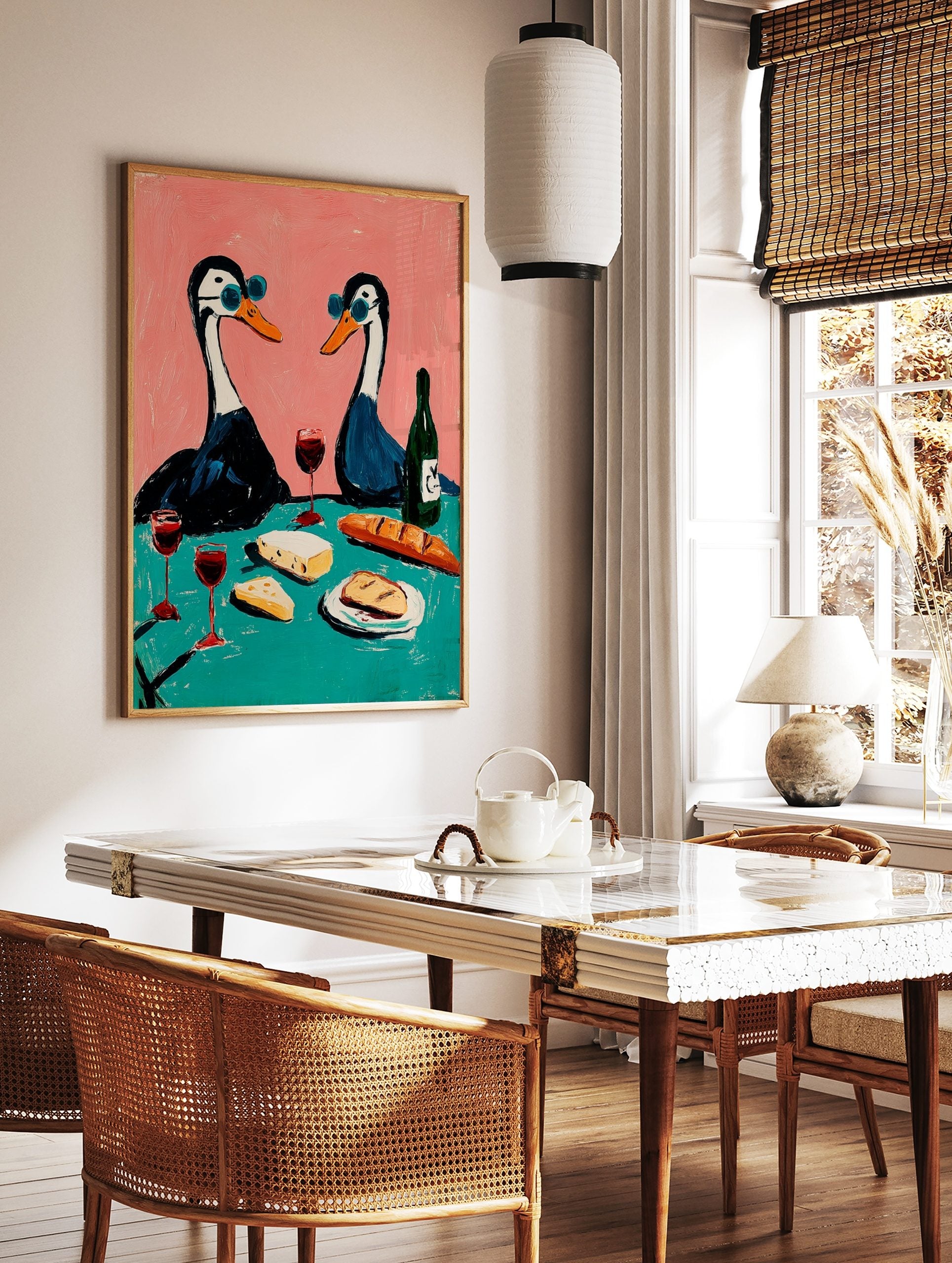 Illustrative art print of two geese in blue sunglasses having a picnic with wine, cheese, and, in a styled room mockup