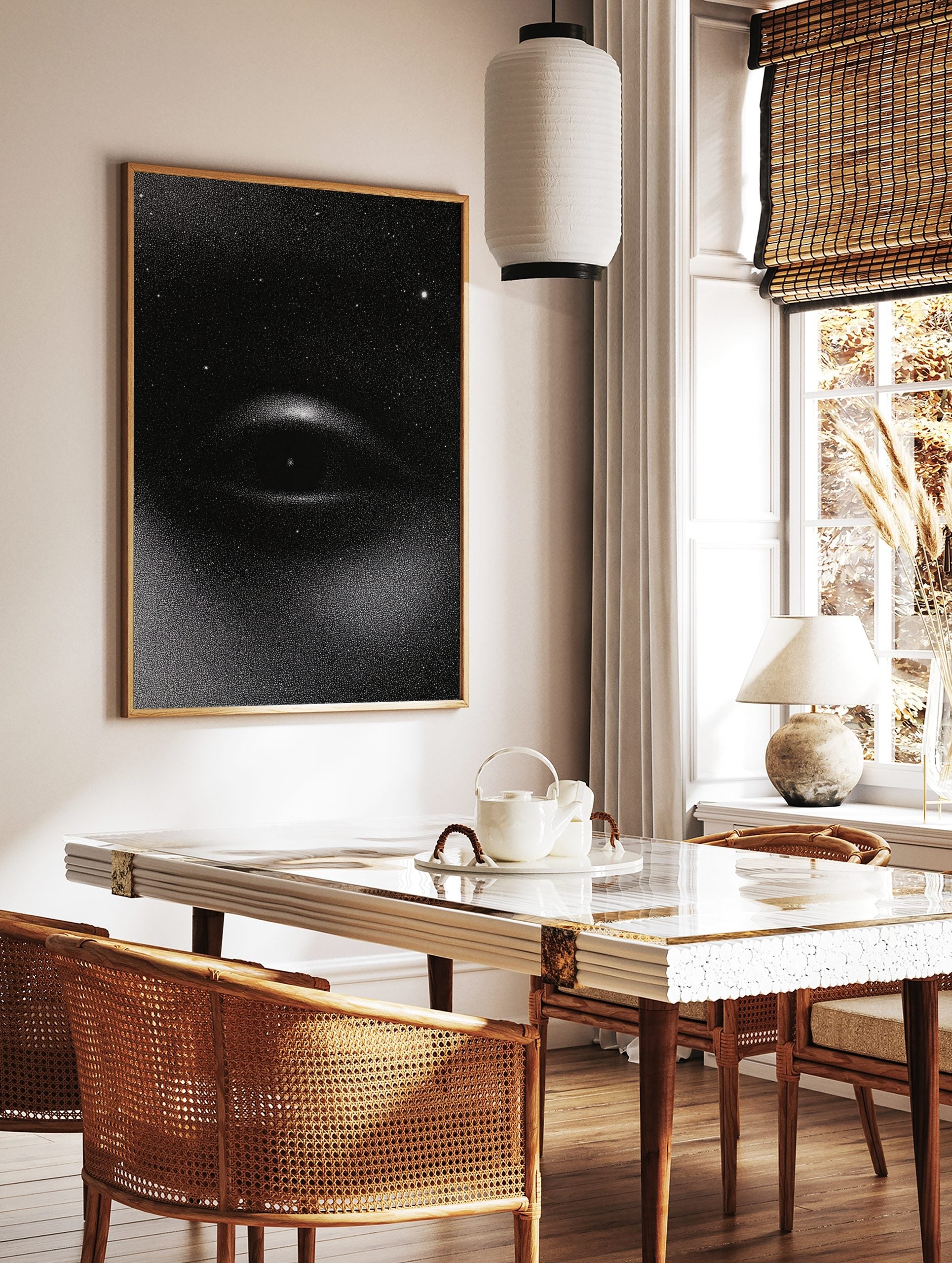 Monochrome stipple print of a cosmic eye with stars on a black background, unframed wall art, in a styled room mockup