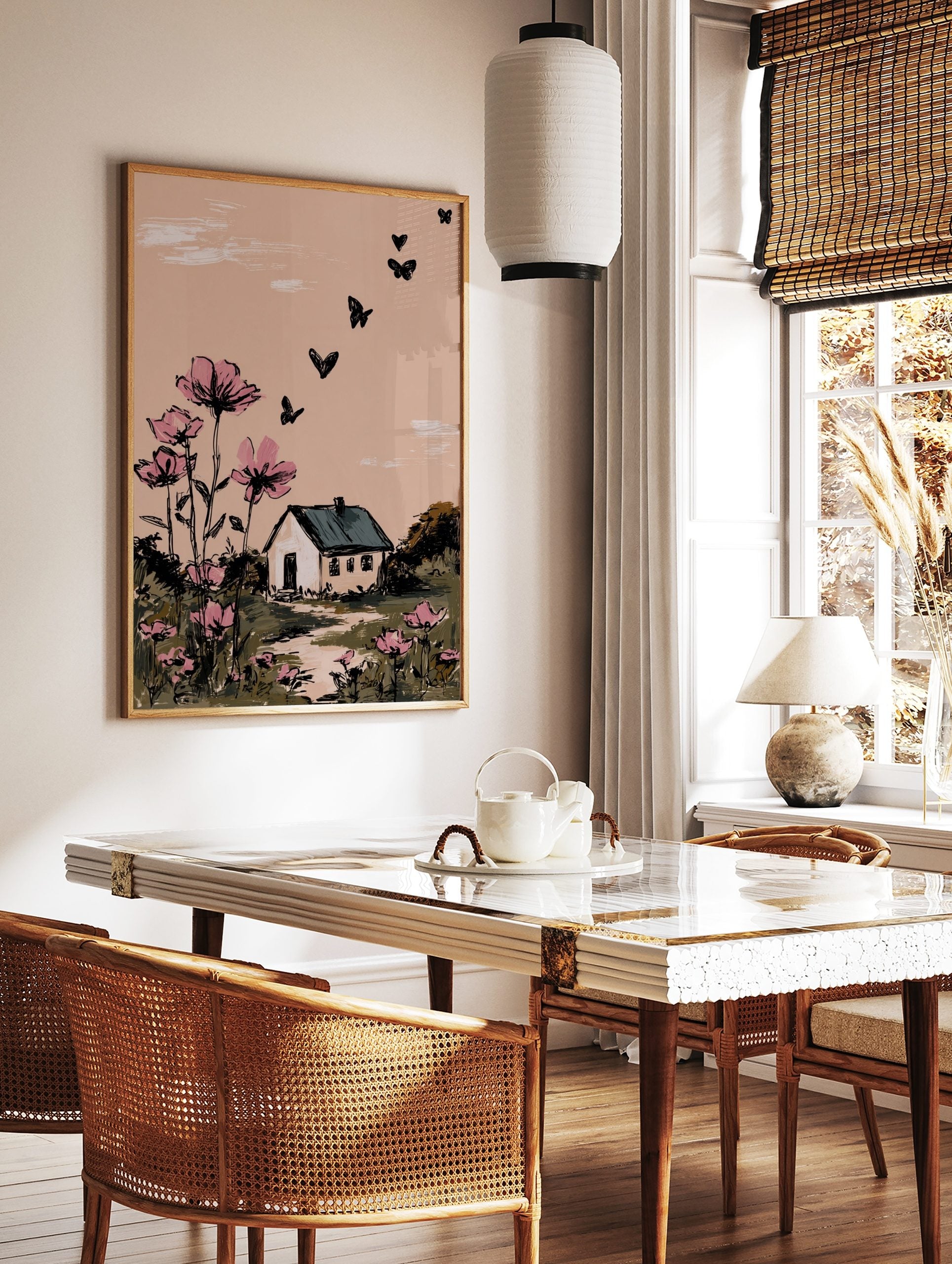 Illustrative wall art with pink cosmos flowers, a white house, and black butterflies against a, in a styled room mockup