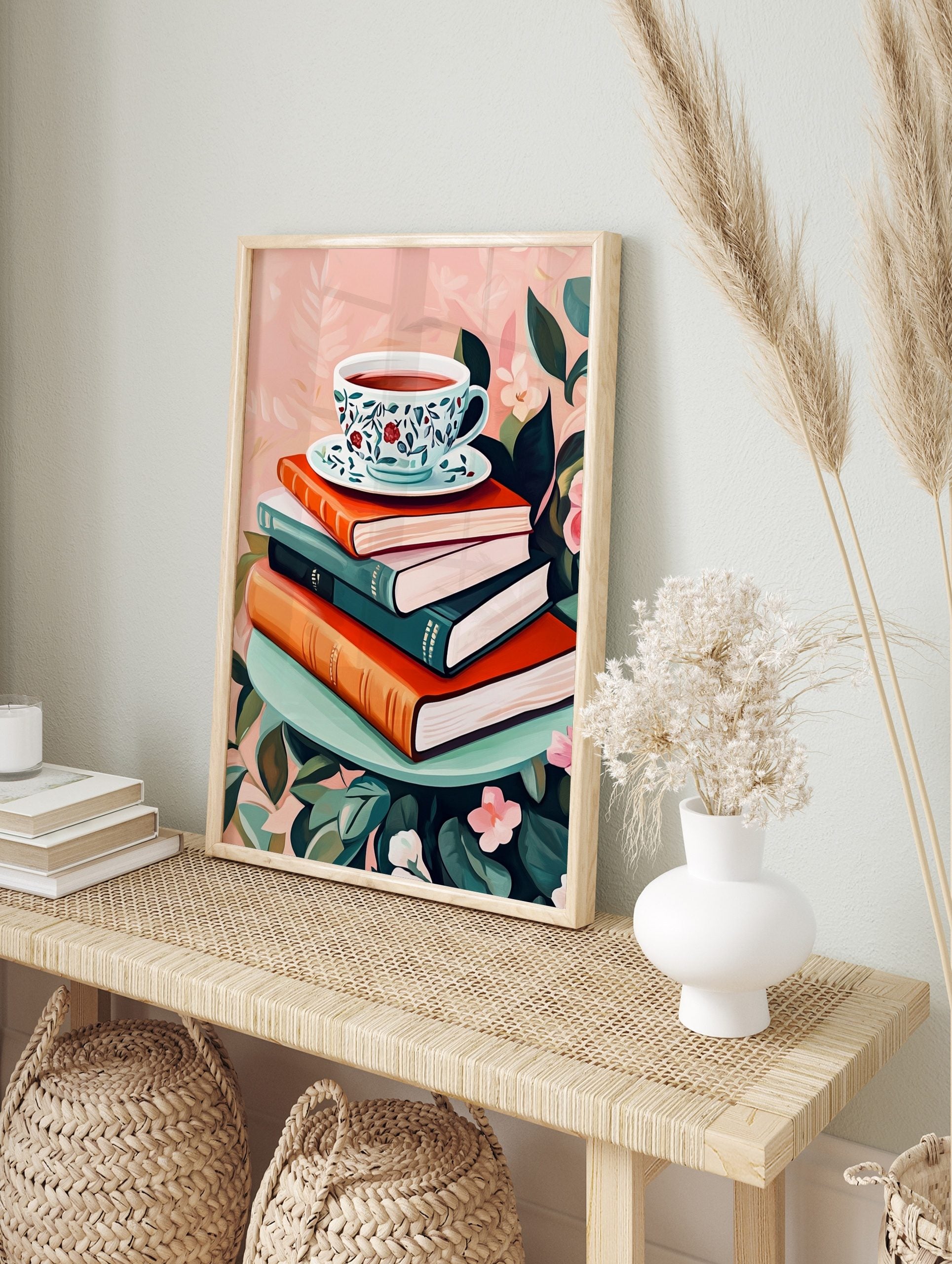 Illustrative art print of a floral teacup on a stack of books, surrounded by green leaves and, in an alternate framed mockup