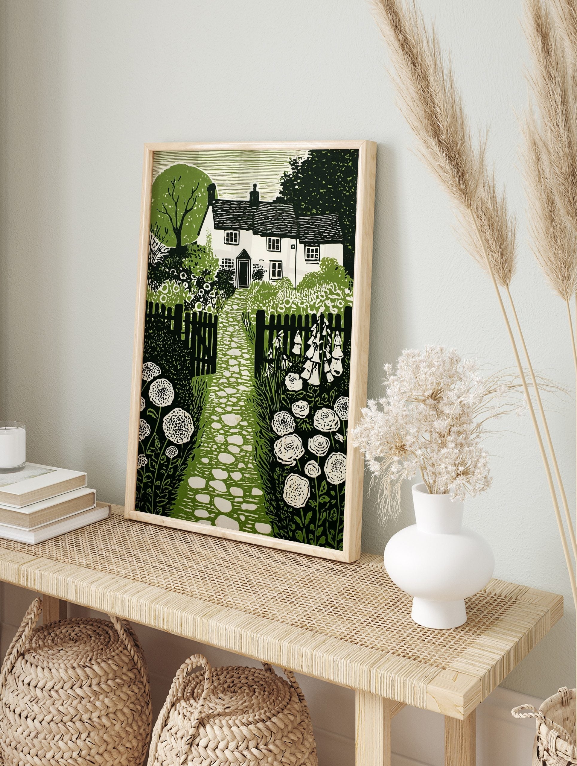Cottage garden green linocut print with house, stone path, picket fence, foxgloves, and, in an alternate framed mockup