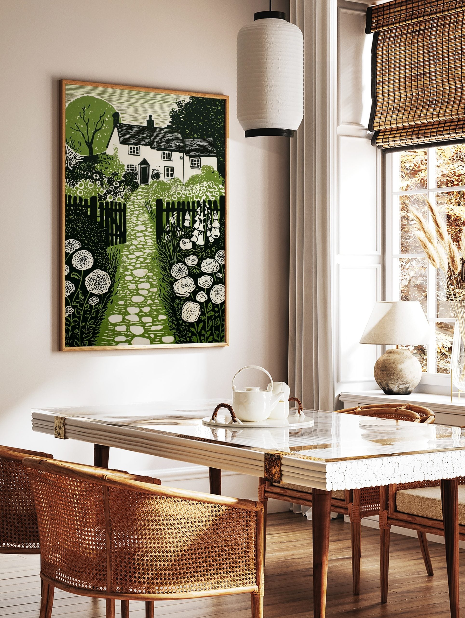Cottage garden green linocut print with house, stone path, picket fence, foxgloves, and allium, in a styled room mockup