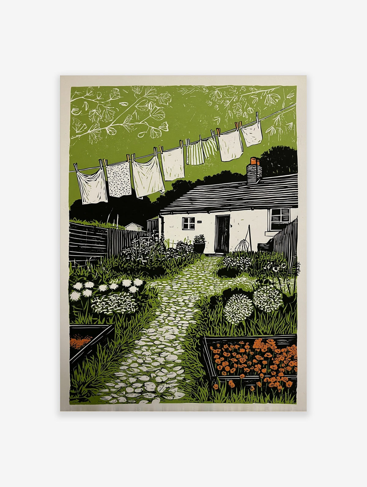 Linocut print of a cottage garden with washing line, white house, green plants, and stone path