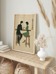 Illustrative print of a man and woman at a bar with wine, in a mid-century modern style with, in an alternate framed mockup