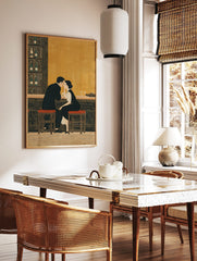 Illustrative print of a couple at a bar, leaning in close, with bottles on shelves and warm golden, in a styled room mockup