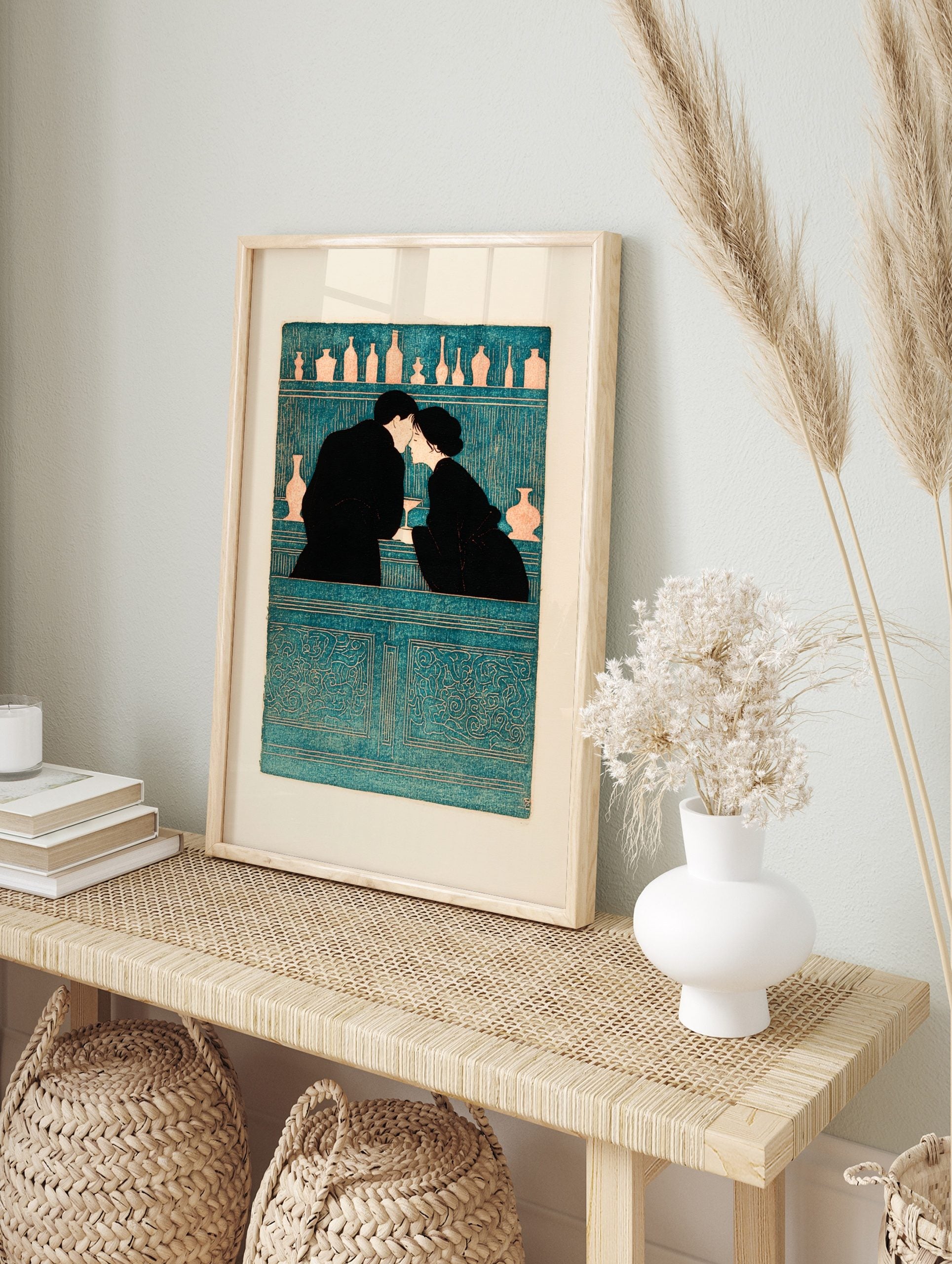 Illustrative teal and black wall art of a couple kissing at a bar with bottles on shelves, in an alternate framed mockup