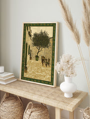 Illustrative courtyard wall art print with a tree, stone walls, table, and chairs, framed by a green botanical border. - Image 3